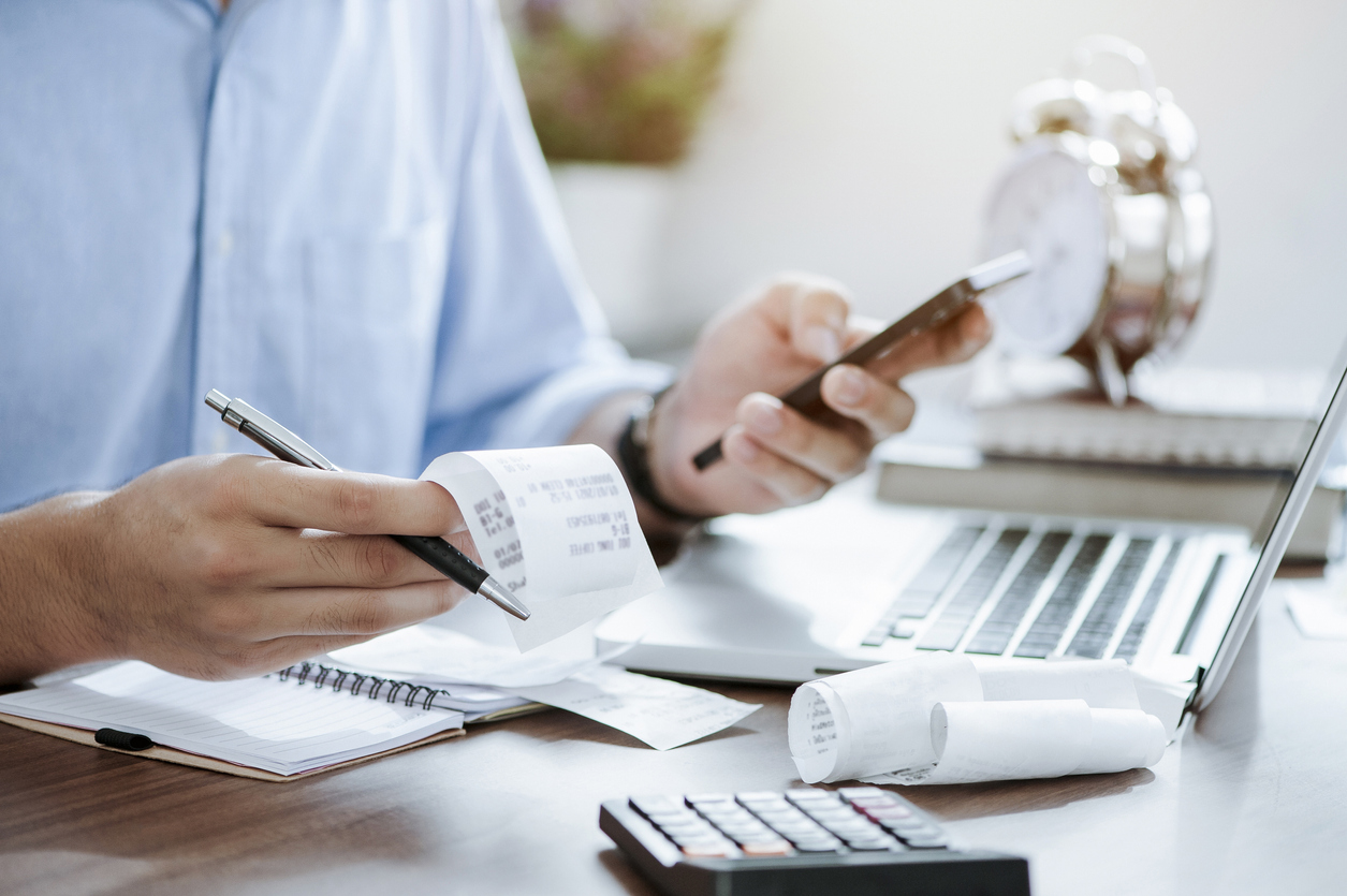 Young Man Holding Pen With Bills Working For Calculate Business Data, Taxes, Bills Payment, Start Up Counting Finance. Accounting, Statistics, And Analytic Research Concept - Contabilidade em São Paulo - SP | Fiscon e Prosper Associados - Quais são as obrigações fiscais para empresários? Saiba tudo!